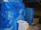 a large pile of blue plastic bags sitting on a pallet