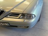 a silver car that is parked in a garage