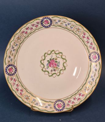 a close up of a plate with a flower design on it