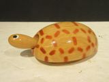a small wooden turtle that is sitting on a table