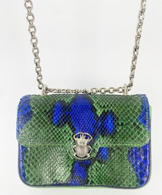 a green and blue snake skin purse with a silver chain