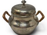 an old silver pot with handles and handles on a white background