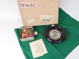 a box with a clock and some other items on a green cloth