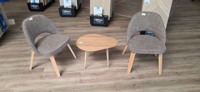 three chairs and a table in a store with boxes