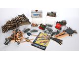 an assortment of toy train tracks and accessories including a book