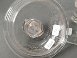 a glass vase with a candle inside of it on a table