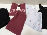 four pieces of clothing are laid out on a table