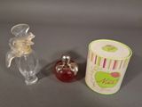 a small bottle of perfume next to a small bottle of perfume