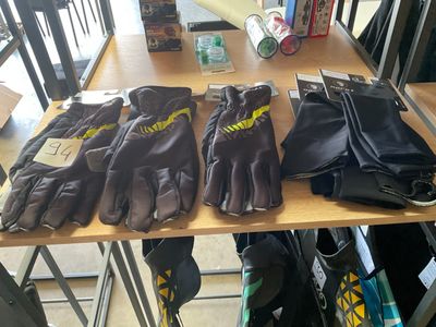 many pairs of gloves on a table in a store