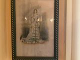 a picture of a woman in a dress hanging on a wall