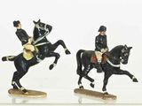 two figurines of a man on a horse and a man on a horse