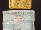 an image of a gold bar sitting next to a piece of paper