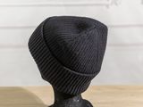 a black hat sitting on top of a mannequin head