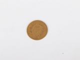a close up of a coin on a white surface