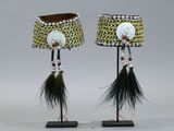 pair of african lamps with feathers and beads on stands