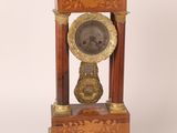 a clock that is sitting on top of a wooden stand