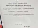a person holding a cell phone with a certificate on it