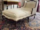 a chaise lounger in the middle of a living room
