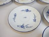many plates and cups sitting on a table