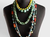 a close up of a mannequin wearing a multi colored necklace