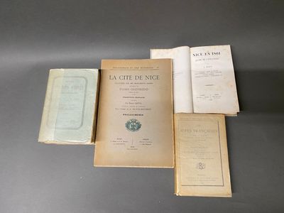 Trois livres sont posés sur une table ; l'un est ouvert et l'autre est fermé.