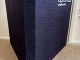 the blue box is sitting on the floor next to the door