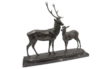 statue of a stag and a baby stag on a wooden base