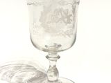 a glass with a design on it sitting on a table