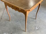 une petite table avec un plateau en bois sur un sol en béton