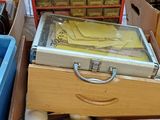 several boxes of assorted items sit on a wooden floor