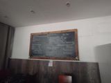 a chalk board on the wall of a restaurant