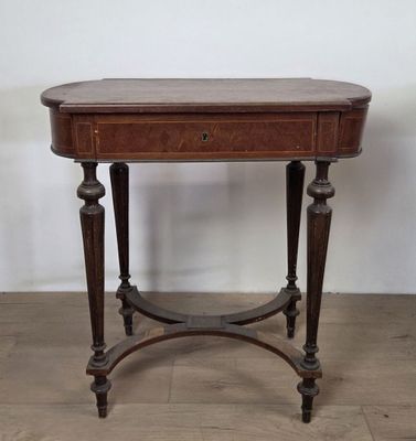 an old wooden table with a drawer on top of it
