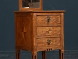 an old wooden dresser with a mirror on top of it