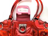 a red purse with a pink phone in it
