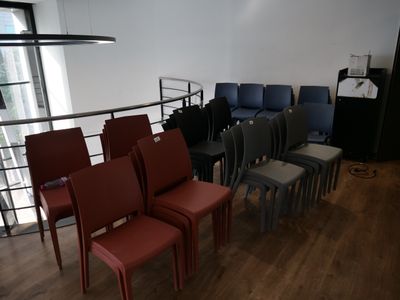 many chairs in a row in a room with wood floors