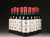 six bottles of red wine are lined up in a row