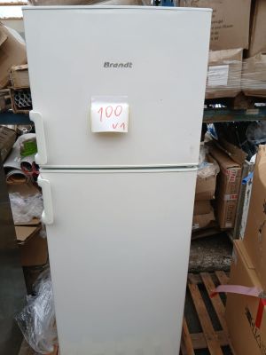 a white refrigerator that is sitting in a warehouse