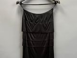a black dress hanging on a hanger in a room