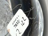 a close up of a glass vase with a tag on it
