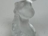 a glass figurine of a man with a ball on his head