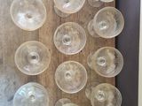 many empty wine glasses sitting on a wooden table