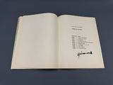 an open book with a picture of a man ' s name on it