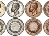 a close up of a bunch of coins with faces on them