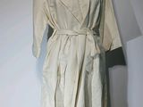 une robe posée sur un présentoir à mannequin, avec un mur blanc en arrière-plan