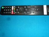 the remote control is sitting on a blue surface