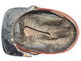 an old black and red bag with a hole in it