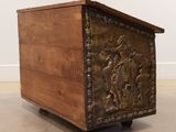 an antique wooden chest with a carved design on the front