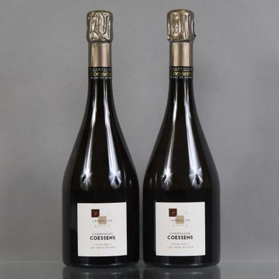 two bottles of wine sitting on top of a table next to each other