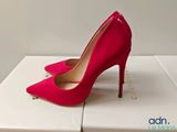 a close up of a pair of red high heels on a box