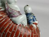 a figurine of a cat and a dog sitting on top of a basket